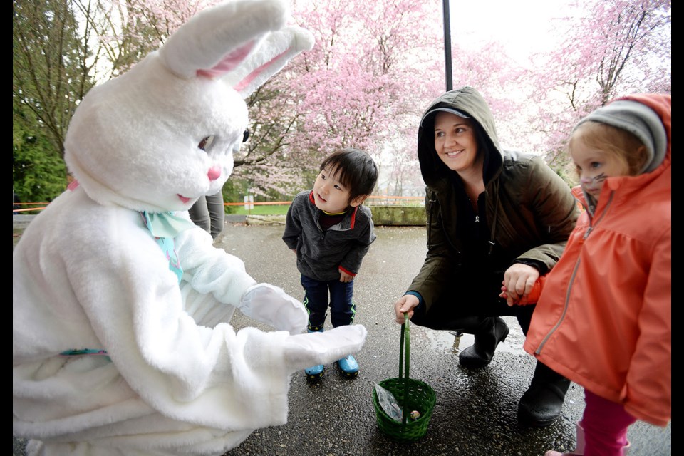 Three-year-old Ariel Jang peers at the Easter bunny during the Hillview Preschool Easter event on April 8.