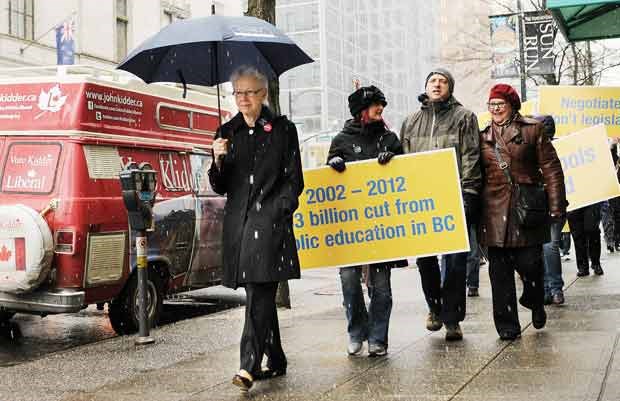 Teachers were on street corners near Georgia and Hornby at noon Monday, waving placards and distributing leaflets.