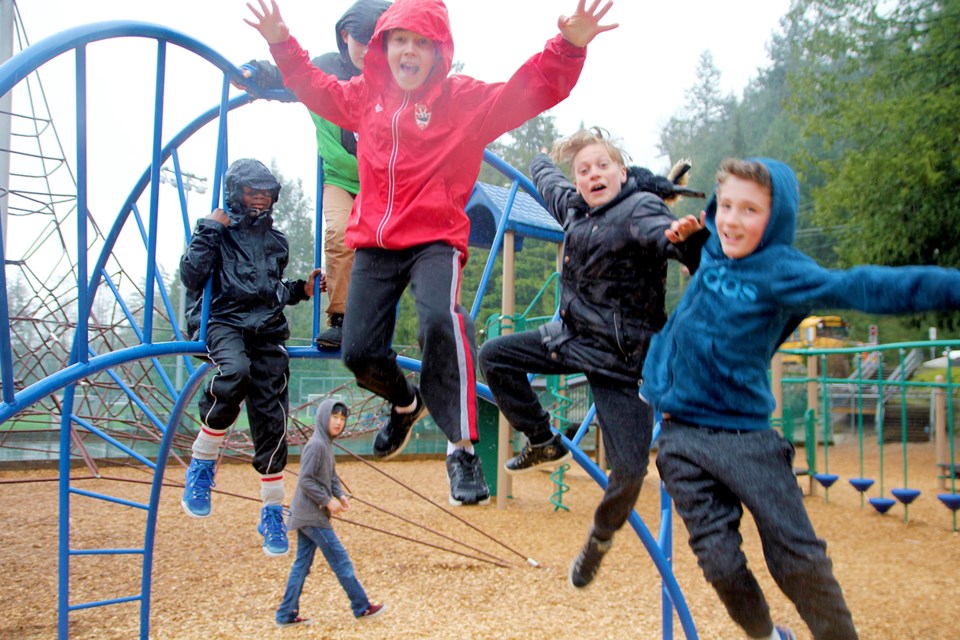 Boys enjoying the new playground equipment.