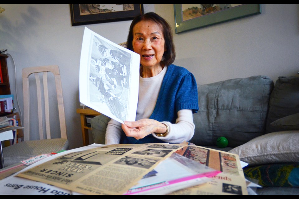 Waffle House founder Susan Chew, at her Vancouver apartment, looks through photos and newspaper clippings from her time in New Westminster in the 1940s and '50s.