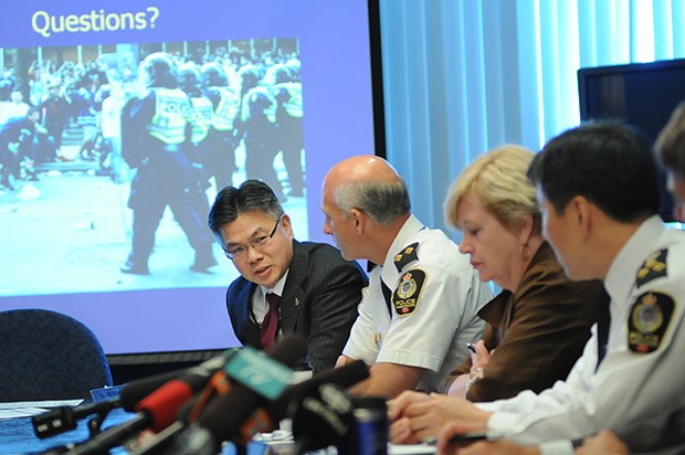 Police Board member Glenn Wong (left) speaks at a special police board meeting Tuesday to discuss the VPD's internal review of the Stanley Cup riot.