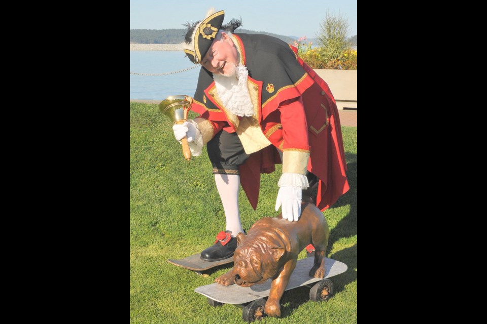 Sidney town crier Kenny Podmore led the charge to raise the funds to purchase Board Dog by local artist Paul Harder for the town's new skatepark, now under construction at Tulista Park. Victoria International Airport contributed $5,000 toward the cost of Board Dog.