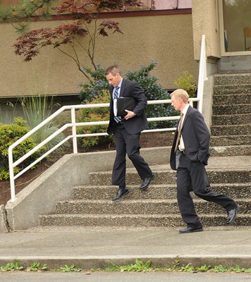 Police detectives exit False Creek elementary school Tuesday after the school received a package containing human remains.