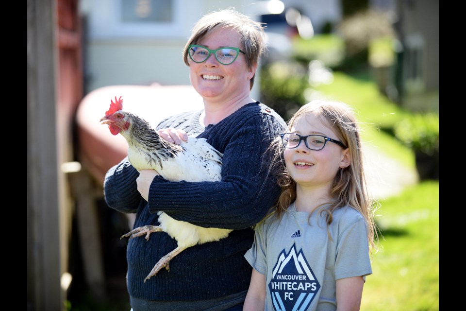 Backyard farming: New West resident Jen Arbo (left) grew up with chickens, so when she and her husband moved from a townhouse to a house with their son Kale (right), setting up a few coops was a no-brainer. But Arbo warns they can be high maintenance.