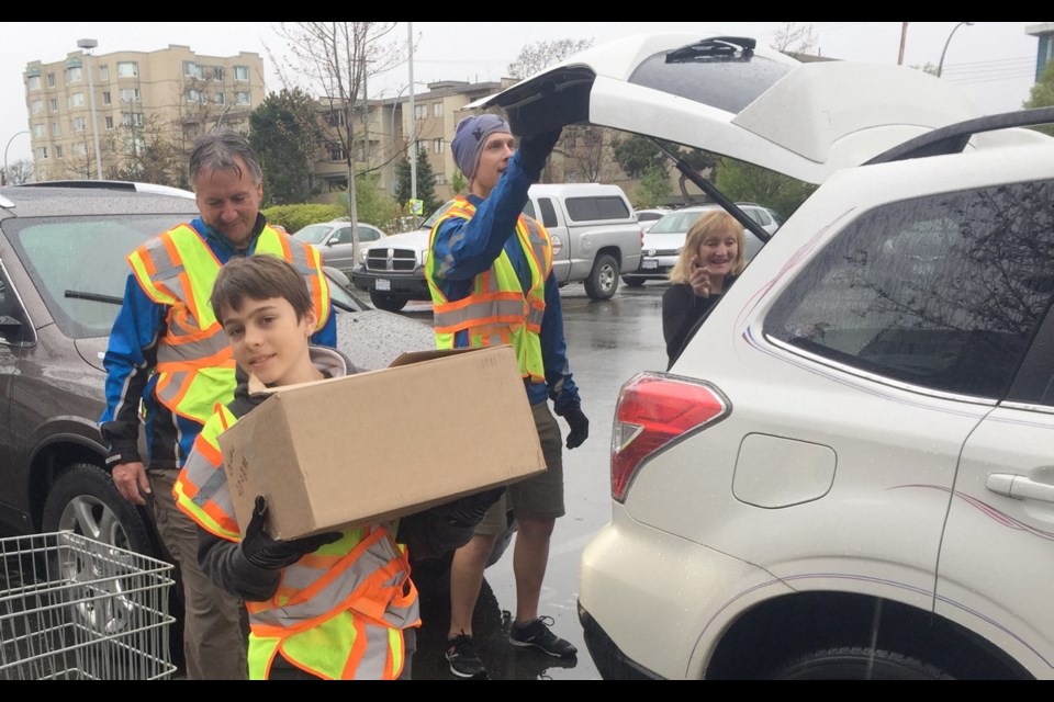 Central Middle School student Marco Joly, 13, pitched in with seasoned book drive volunteers at Victoria Curling Rink on Saturday, April 22, 2017.