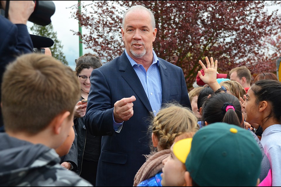 B.C. NDP leader John Horgan takes questions from a group of Gilmore Community School students at an election stop in North Burnaby Wednesday.