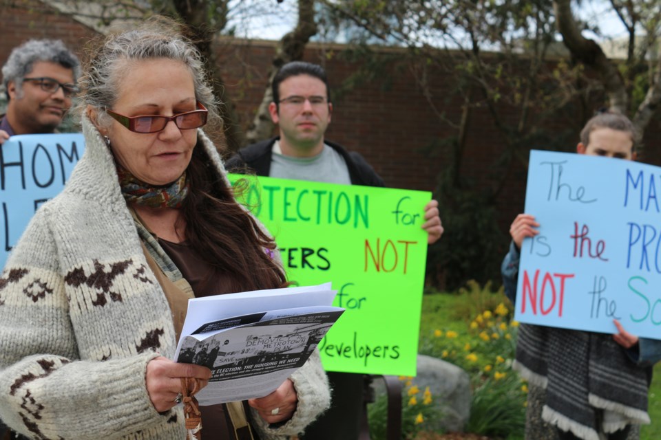 Leslie Madison speaks at a Stop Demovictions Campaign press conference on Tuesday night outside Bonsor Recreation Complex. The activist group released a "report card" on the Burnaby-Deer Lake candidates' response to housing issues.