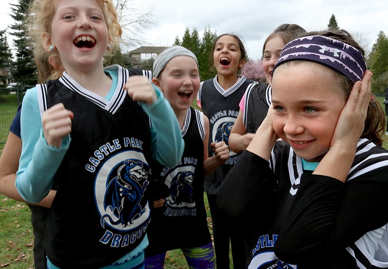 MARIO BARTEL/THE TRI-CITY NEWS Zosia Gnatek doesn't quite share the loud enthusiasm of her Castle Park Dragons' teammates as they get ready for the start of the Grade 4 races at the annual Como Lake Relays on Wednesday.