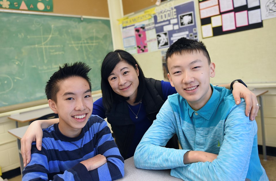 Grade 9 David Thompson secondary students Jonathan Cao (left) and Ollie Zhao, along with teacher Sus