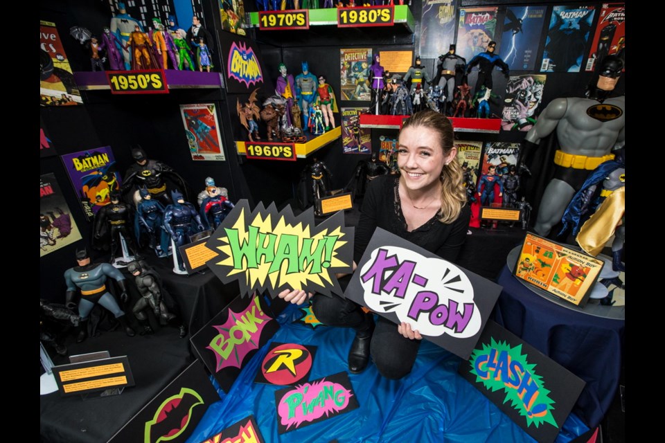Sidney Museum volunteer Ashley Hopper, 24, is surrounded by several decades' worth of Batman collectibles, reflecting how the character has evolved since his creation.