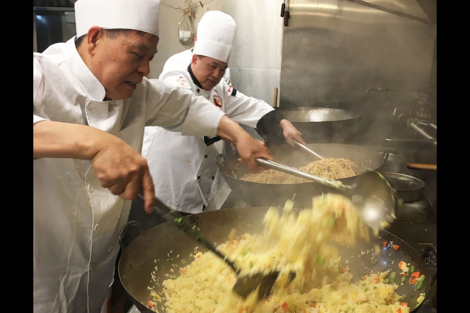 Working the large, fully ladened woks at the Pink Pearl requires strength and dexterity. Executive chef Kuen Kwan and chef de cuisine Tommy Yip take pride in the resulting "wok magic."