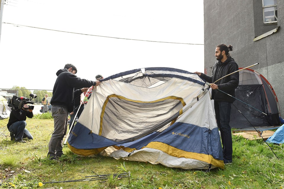 Tents go up at 950 Main St. on April 28, 2017. Photo Dan Toulgoet