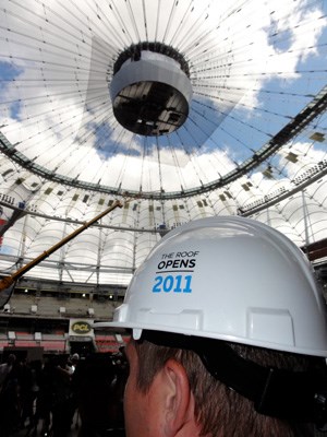 The west end of B.C. Place Stadium is covered by new fabric roofing, but crews are hurrying to finish the rest by Sept. 30. B.C. Pavilion Corporation reported 10,800 people attended the three-hour open house on Sunday. They saw 13 of the 36 fixed fabric roof panels in place and nearly half the 54,500 seats installed.