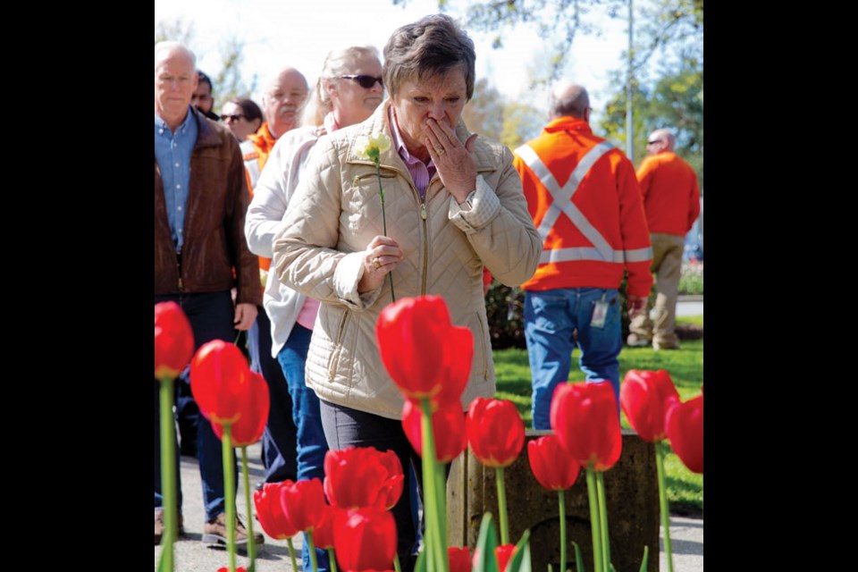 Those attending a recent Day of Mourning ceremony laid flowers at a monument in Rotary Park adjacent to Delta Municipal Hall. The annual event, organized by CUPE Local 454, pays tribute to B.C. workers who have lost their lives to workplace injury and disease.