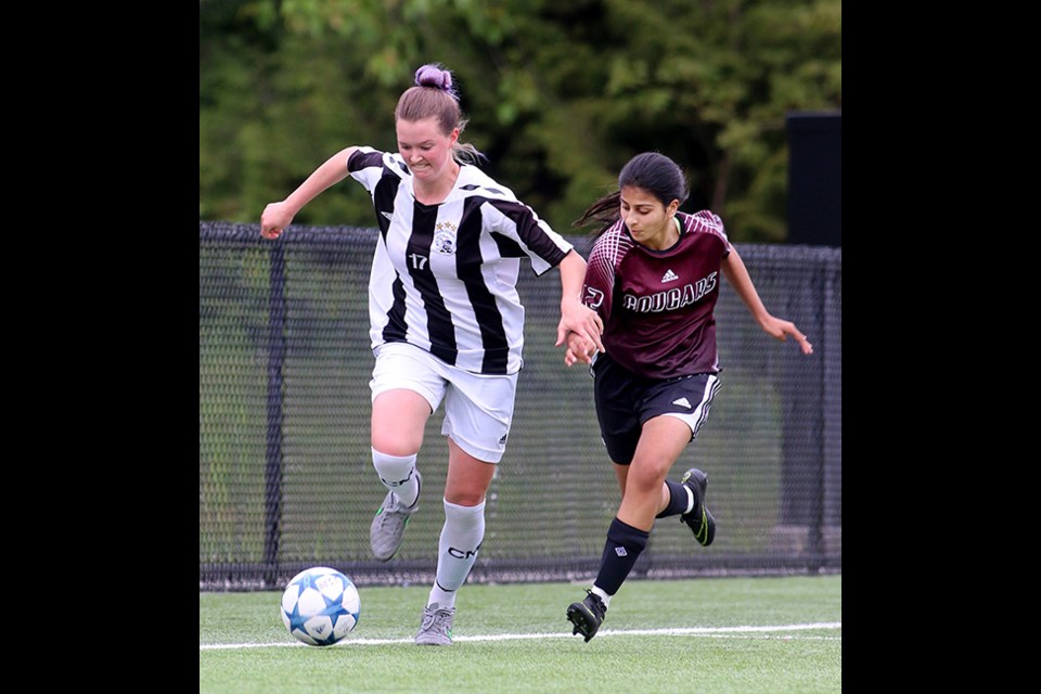 MARIO BARTEL/THE TRI-CITY NEWS Charles Best forward Kathleen Deady tries to outsprint an Enver Creek defender in the second half of their second round match at the Fraser Valley Girls AAA High School Championships, Wednesday at Charles Best turf. Best won the match 9-0 and will play Sardis secondary on Monday. Heritage Woods Kodiaks, who went into the tournament undefeated, recovered from their upset 2-1 loss to Enver Creek in the first round to defeat Earl Marriott 5-2. Terry Fox and Centennial both lost their second round matches.