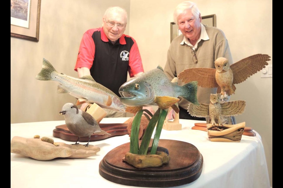 Richmond Carvers Society treasurer John Scott, left, and society secretary Dave Price show off some of their creations ahead of their club’s big annual show at the end of the month, when dozens of amazing carvers from Canada and the U.S. are expected to vie for some top prize money.