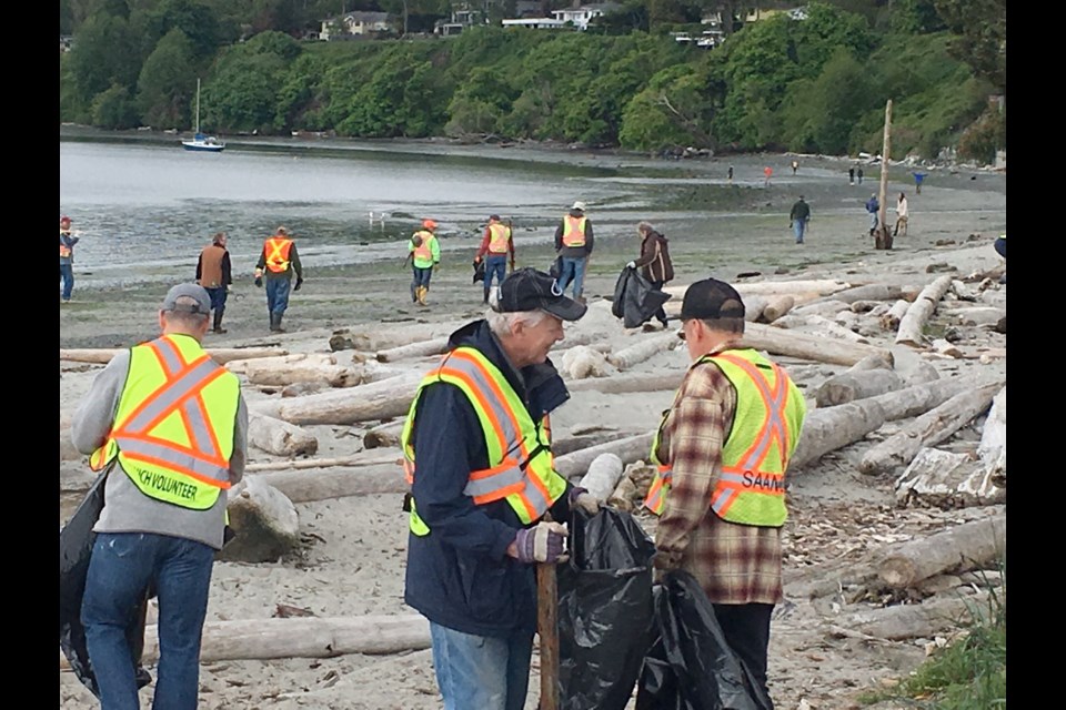 More than 40 volunteers turned up at Cadboro Bay Beach at 10 a.m. Saturday, May 13, 2017, to help clean up the derelict boats littering the beach.