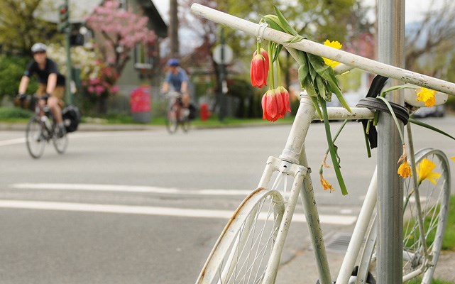 Ghost Bike at the intersection of East 12th Avenue and Windsor Street includes sign ³In memory of Amy Hurn² hand-written in black marker.