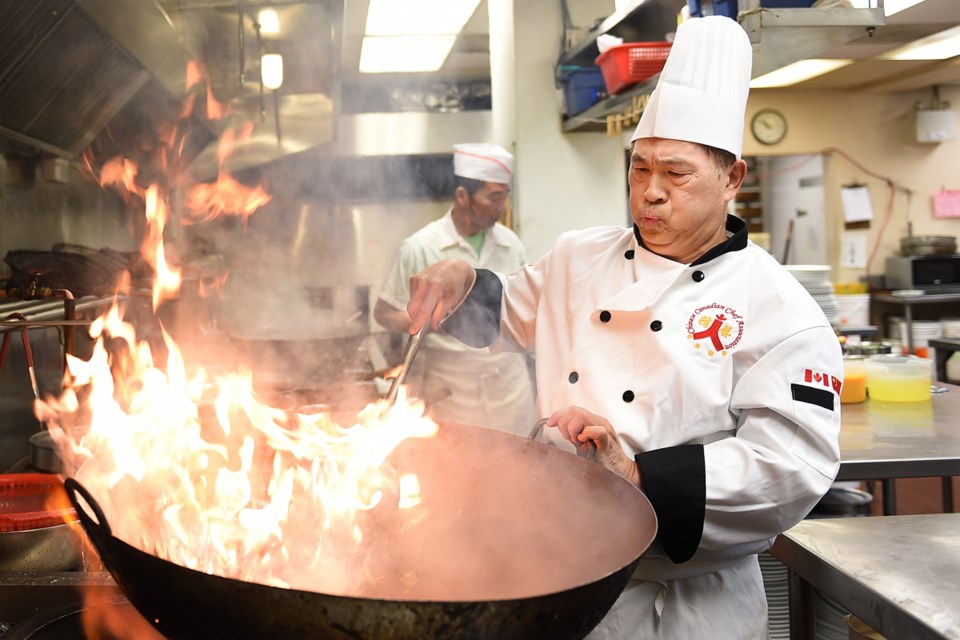 Tommy Yip works the wok at the Pink Pearl restaurant . Photo Dan Toulgoet