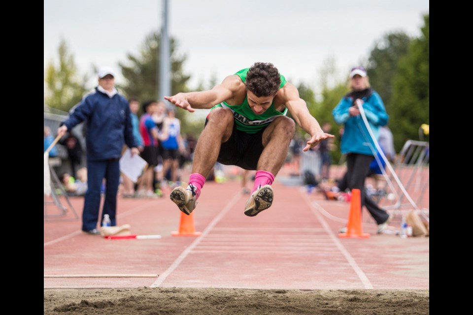 Oak Bay High's Valdi Alarie flies through the air during a triple jump at the Island high school track and field championships Wednesday at Centennial Stadium.