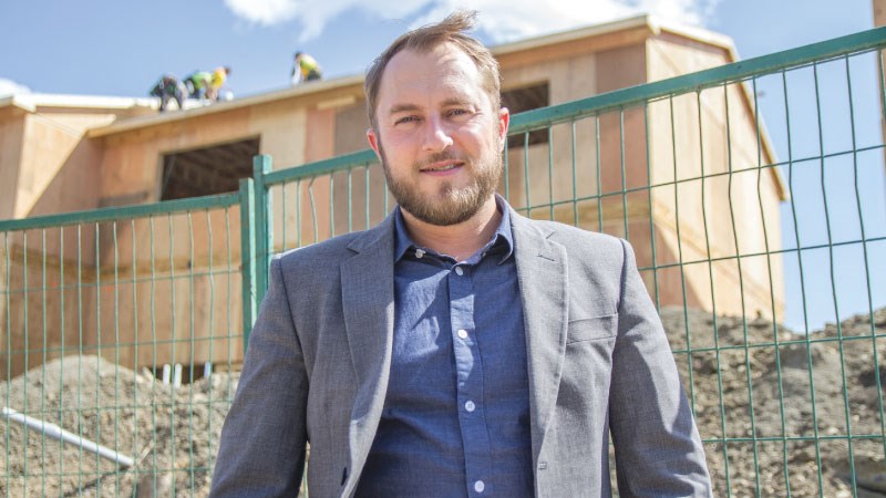 Andrew Weir, president of the Fort McMurray Real Estate Board, at a housing rebuilding site in the hard-hit Abasand neighbourhood: sales of homes are up, but prices are lower than last year. | Robert Murray
