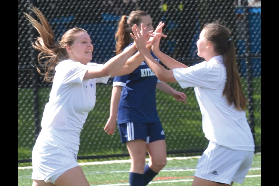 Lauren Dickson (left) celebrates her goal which proved to be the game winner in McMath Wildcats' 1-0 triumph in Vancouver and District AAA girls soccer final on Tuesday at Minoru Park.