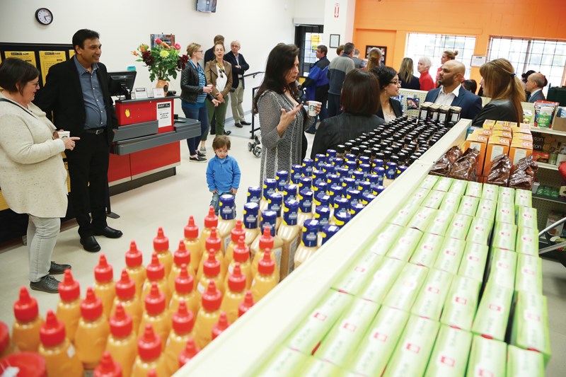 A crowd gathers at Quest Food Exchange for the grand opening of their Lower Lonsdale location earlier this month. The non-profit grocery store collects surplus food from local suppliers and sells it to those in need. photo Lisa King, North Shore News