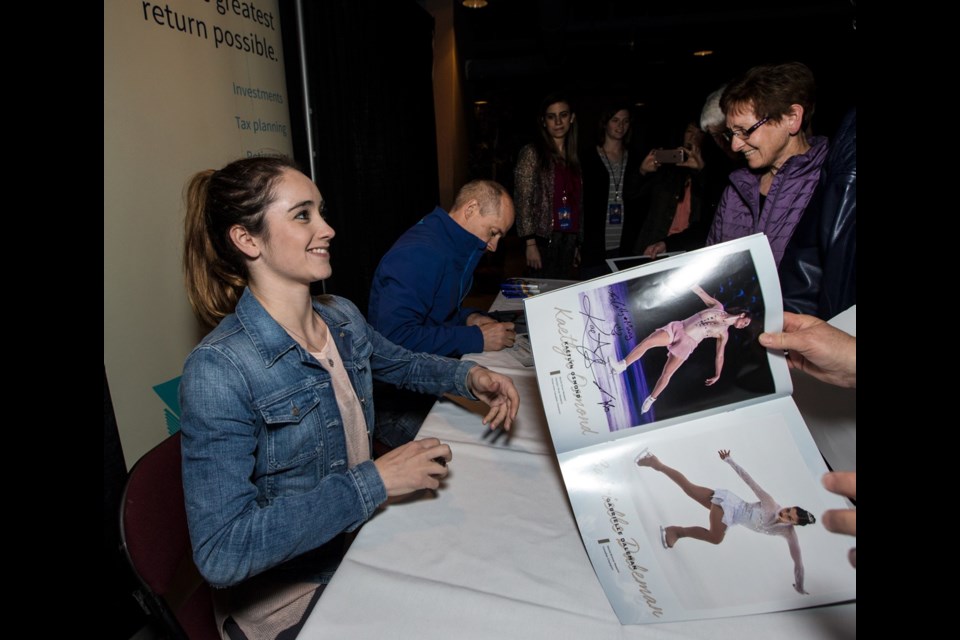 Kaetlyn Osmond and Kurt Browning sign autographs at a reception for Stars on Ice at the Save-on Foods Memorial Centre on Tuesday.