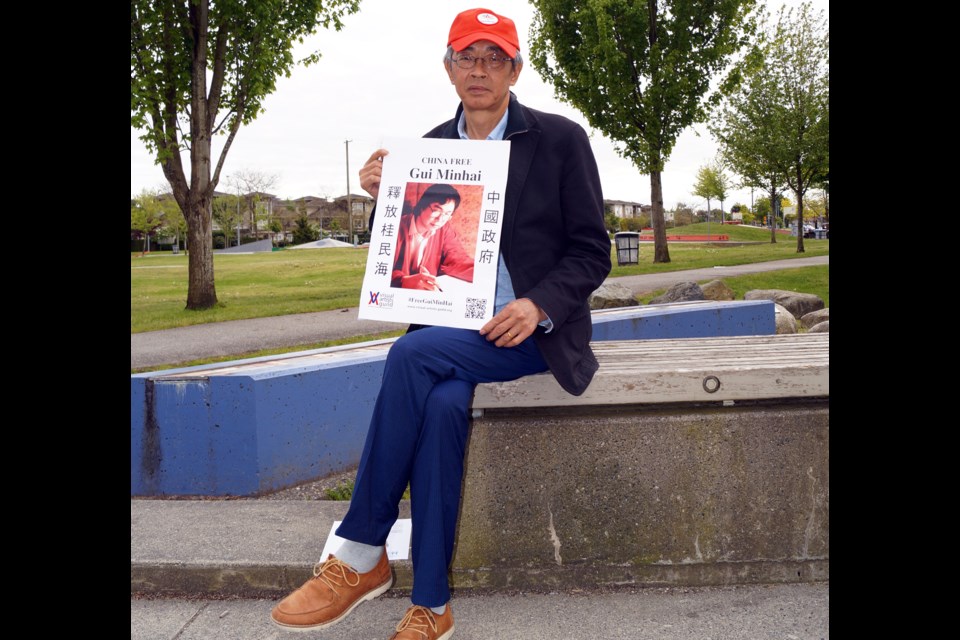 Lam Wing-kee, pictured here at Thompson community centre on May 19, 2017, became a social activist for human rights in China after being kidnapped and imprisoned by Chinese officials, in 2015, for selling books. He is holding a picture of a detained scholar, Gui Minhai.