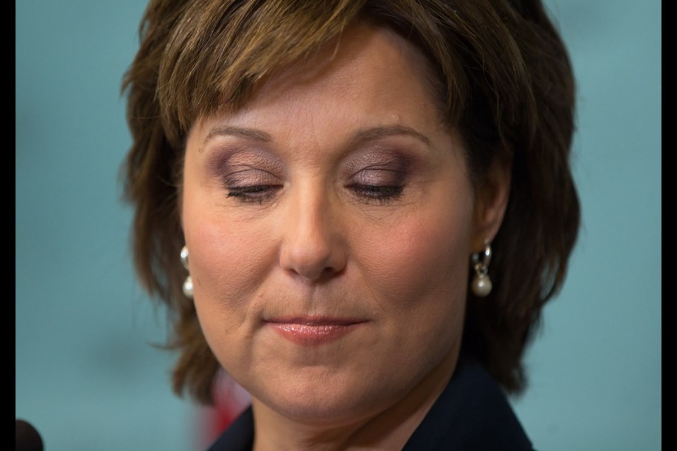 Premier Christy Clark pauses to pick up a glass of water during a news conference in Vancouver on Tuesday. Clark said constitutional convention and historical precedents require her to meet the house rather than step aside now to make way for the NDP-Green alliance.