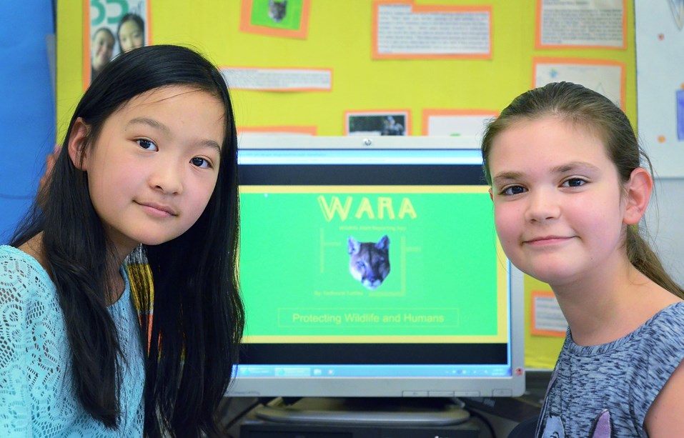 Carina Chen, left, and Isadora Vieytes pose with their Wildlife Alert Reporting App, a mobile tool created for Technovation, a global technology contest for girls.