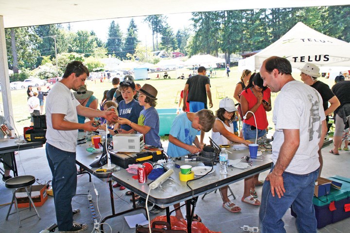 Kids learn as they disassemble and reassemble at the RE Station (REpair, REmake, REuse).