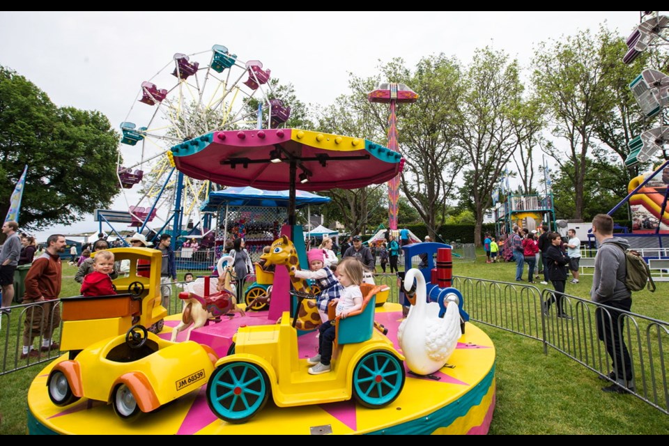 Children flock to the rides on the midway in Willows Park on Saturday.