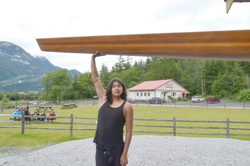 Jonis White loads a racing canoe onto his family’s van at the Stawamus Waterfront. White is heading to the North American Indigenous Games.