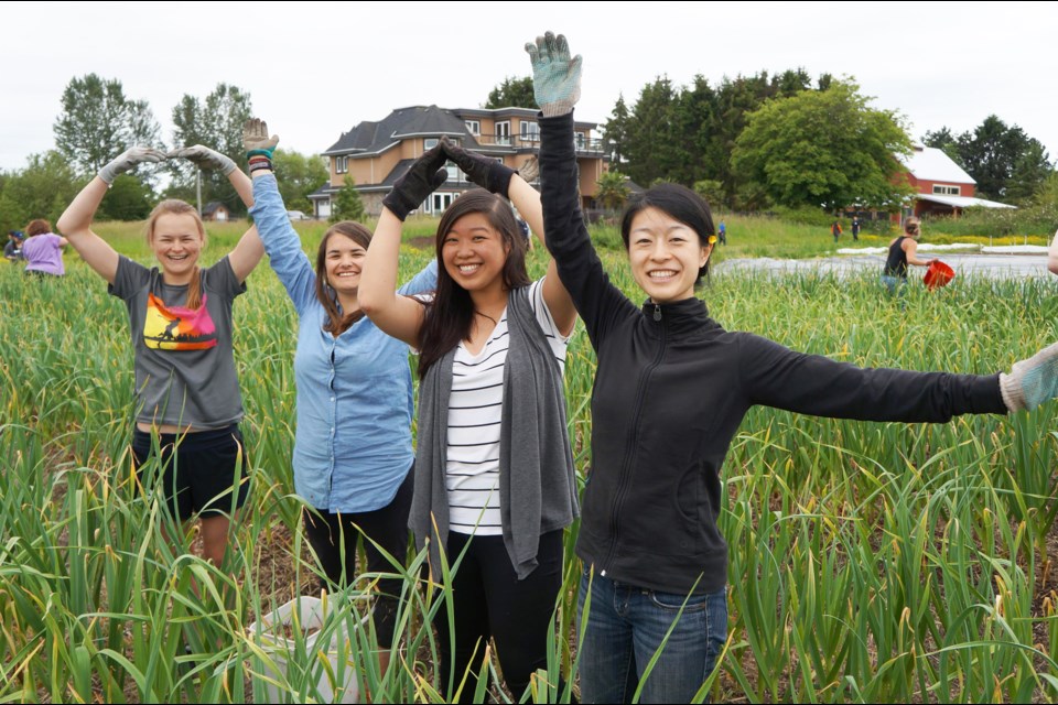 Employees from the Richmond Olympic Oval take a break from volunteering to spell out the name of their workplace.