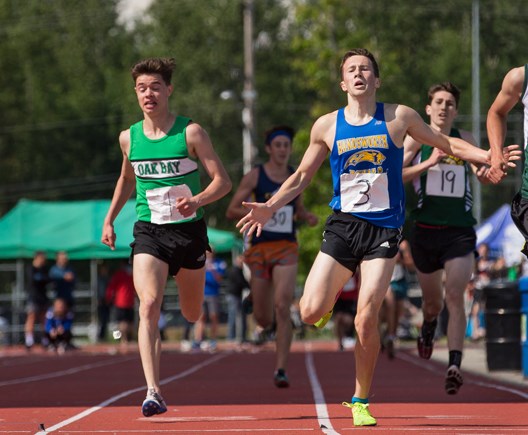 Handsworth's Charlie Dannatt (right) leans over the line just ahead of his good friend Tyler Dozzi at the B.C. High School Track and Field Championships Saturday at McLeod Athletic Park in Langley. Both runners shattered the record in the 3,000-m race, with Dannatt edging Dozzi by 0.3 seconds. photo Mark Bates