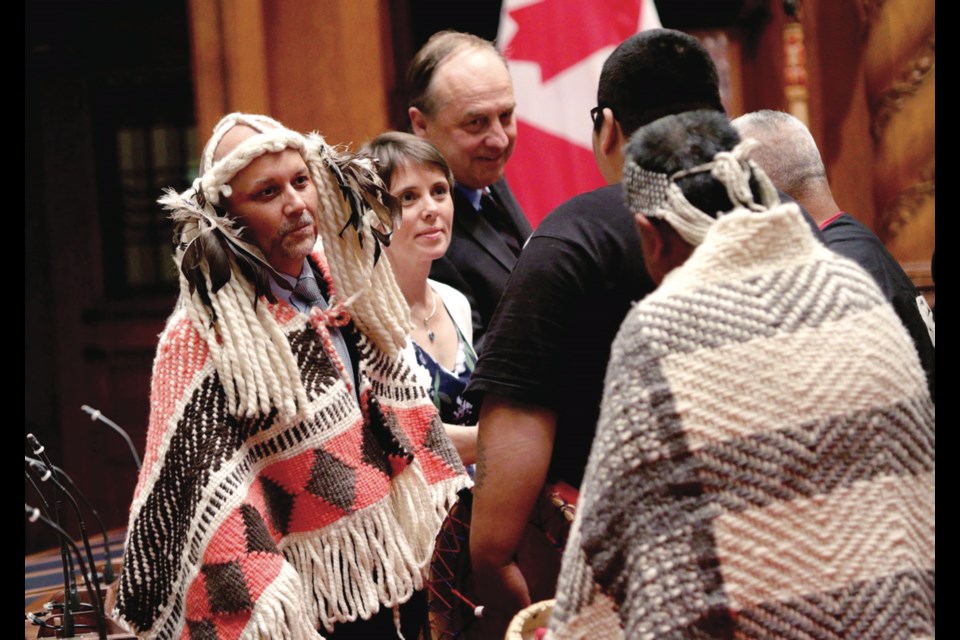 The B.C. Green Party's Adam Olsen, left, Sonia Furstenau and Andrew Weaver greet Tsartlip First Nation drummers before being sworn in as Island MLAs during a ceremony at the legislature. June 7, 2017