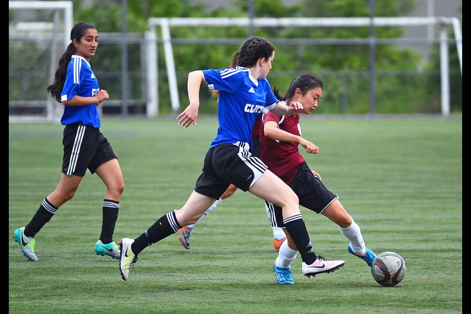 The Burnaby North Vikings’ Erika Lieu, right, tries to cut across a Clayton Heights defender during Day 1 of the senior girls AAA provincials at Burnaby Lake West.
