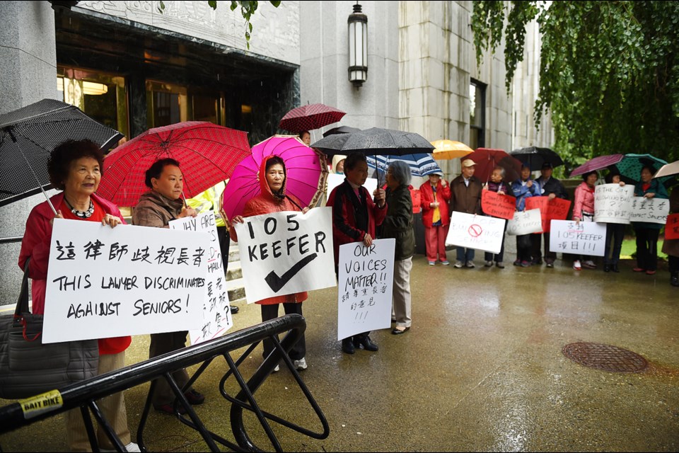 About 60 Chinese seniors gathered Thursday on the front steps of city hall to show their support for a 12-storey condo development in Chinatown. Council will vote on the project June 13. Photo Dan Toulgoet