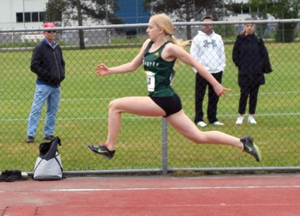 Argyle’s Kristen Schulz springs into action at the B.C. High School Track and Field Championships. The Grade 11 student won gold in the long jump and triple jump despite not being able to train for six weeks before the meet. photo supplied