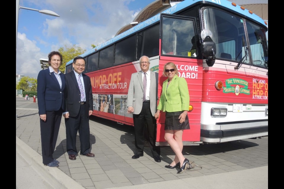 Mayor Malcolm Brodie (second from right) was one of the first to check out Richmond's new hop-on, hop-off tour bus, along with (from left) councillors Linda McPhail, Chak Au and Carol Day