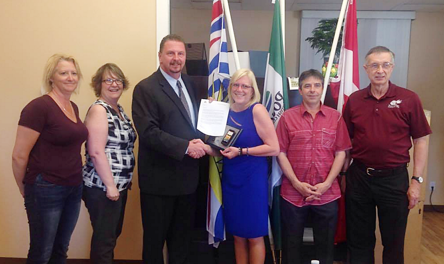 Doug Mac Donald, ICBC road safety coordinator, recognizes Pouce council.