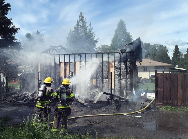 Prince George Fire Rescue battle a fire Wednesday afternoon in the garage of a MacDonald Avenue home. Citizen photo by Brent Braaten