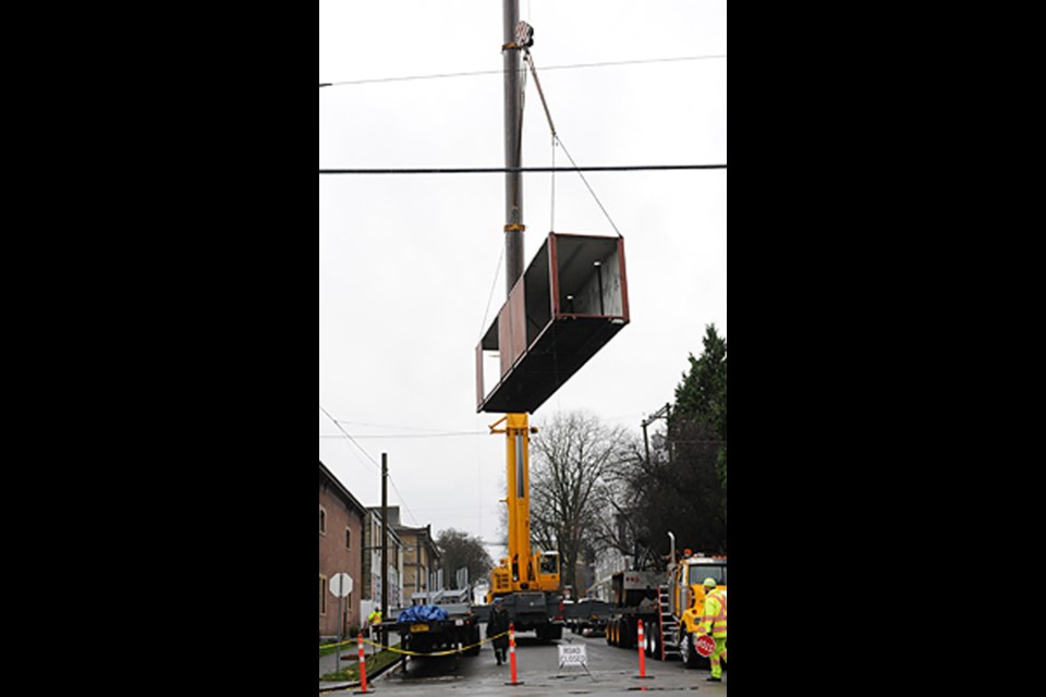 A crane unloaded and stacked the shipping containers that will be converted into 12 units of social and affordable housing near Alexandra and Jackson. This project was developed by Atira Women's Resource Society and JTW Consulting.