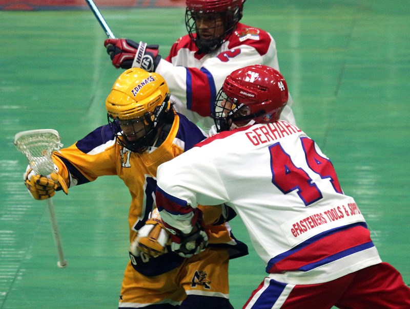 MARIO BARTEL/THE TRI-CITY NEWS
Coquitlam Adanacs forward Philip Buque squeezes through a pair of New Westminster Salmonbellies' defenders in the first period of their BC Junior A Lacrosse League game, Tuesday at Queen's Park Arena in New West. The Adanacs stormed back from a five-goal deficit to win 9-8.