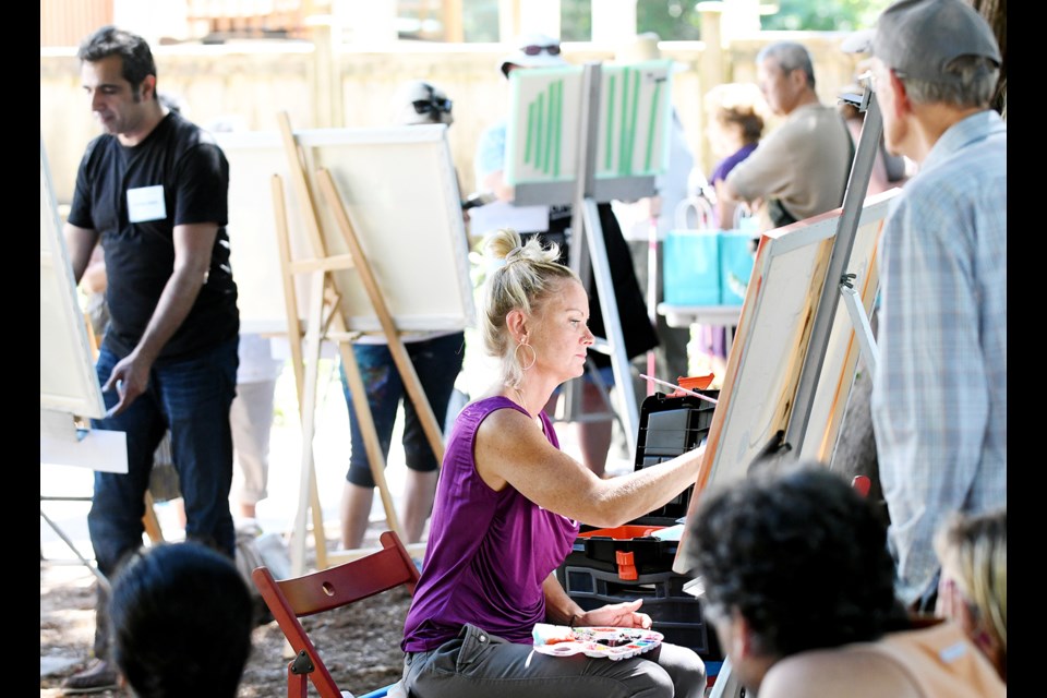 Artists at work at last year's Deer Lake Summer Arts Festival. This year's festival, complete with Park's Edge Paint-Off, returns on Saturday, July 8.