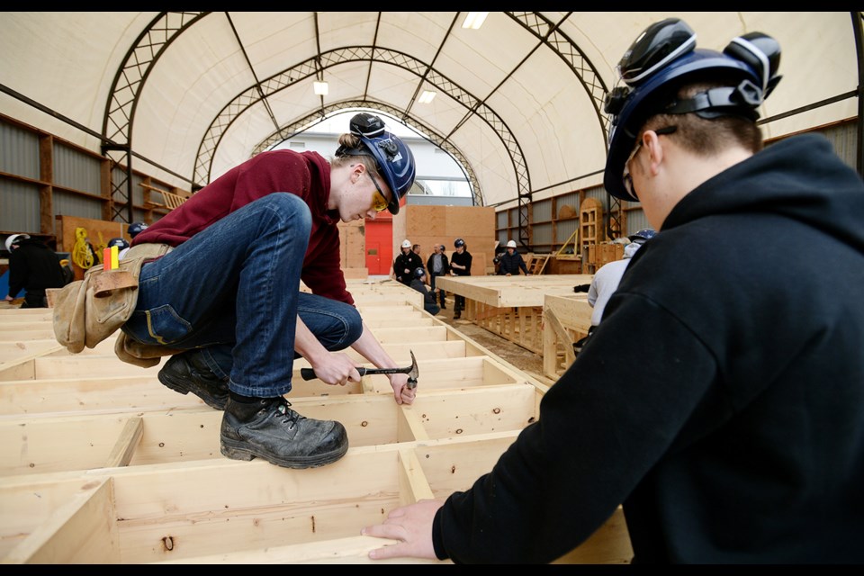 New Westminster Secondary School apprenticeship students work on a floor frame substructure at BCIT. The lesson is part of the practical training students receive when they enrol in a high school apprenticeship program. Staff at New Westminster Secondary School say trades jobs are still seen as low-status jobs, inferior to jobs that require a university degree. They would like to see more students signing up for trades program or apprenticeships.
