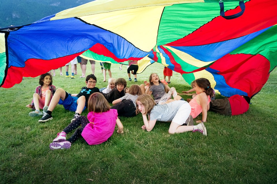 Children celebrate at the 20th anniversary celebration of L'école les Aiglons on Friday.