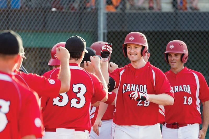 North Vancouver native Derek Mayson celebrates with members of Canada’s national fastpitch team. The squad, which won gold at the 2015 World Championships and Pan Am Games, will be playing in Vancouver this weekend at the Bob Law Memorial Fastpitch Challenge, their first appearance in B.C. in more than 10 years. photo Just Sports Photography/Softball Canada