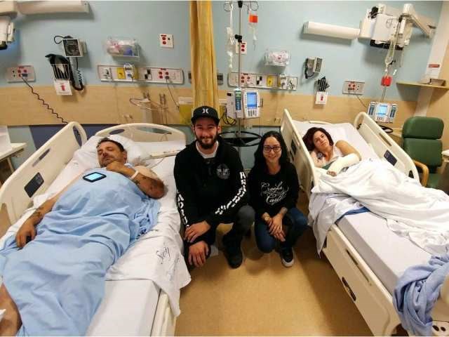 Airn Plonka and Danielle Bleaney (centre) visit friends Brian Fox and Michelle Periera at Abbotsford General Hospital on Monday.